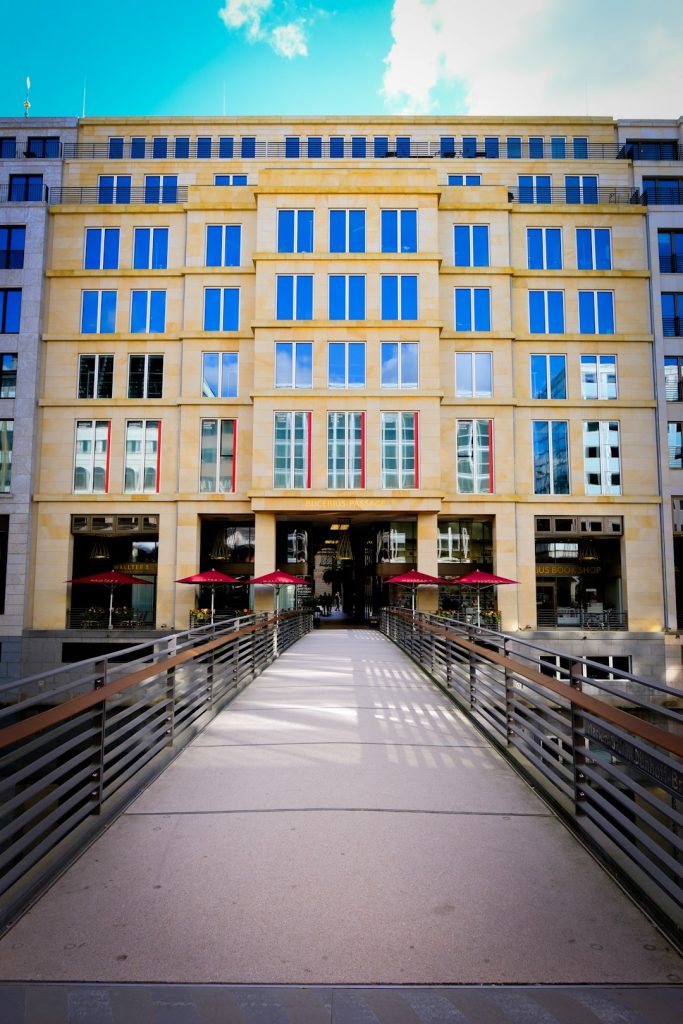 modern-building-with-blue-windows-and-red-umbrellas-t0sfbemziu